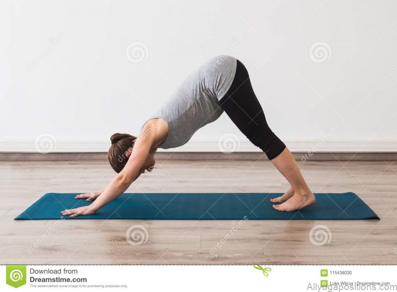 pregnant woman doing prenatal yoga downward facing dog posture studio turquoise mat 115438030