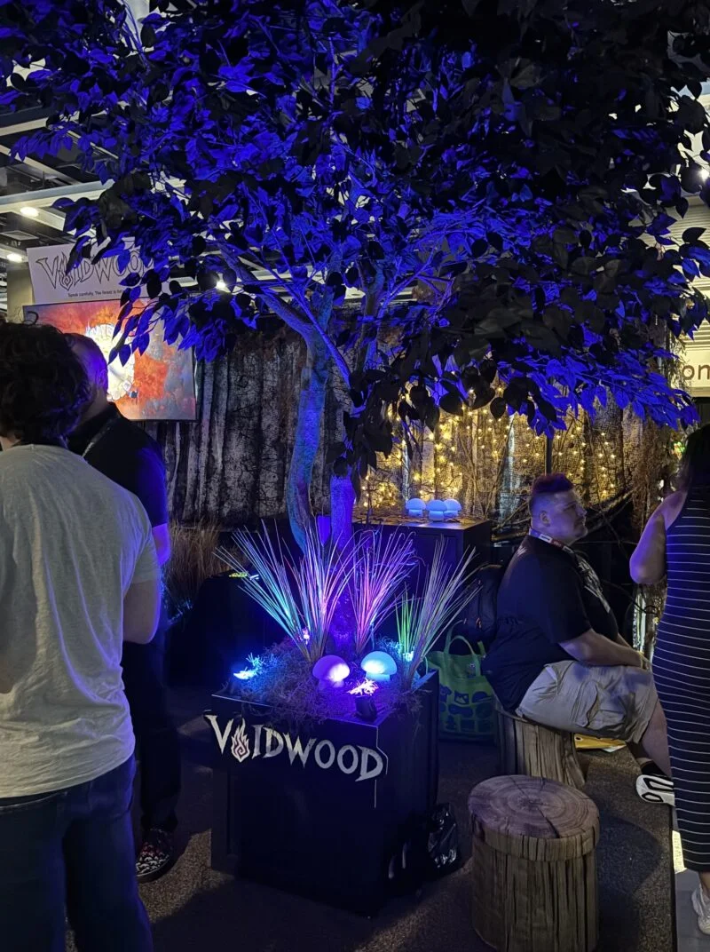 PAX West 2026: A tree is bathed in a neon blue glow.