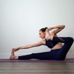 the art and benefits of dandayamana dhanurasana yoga pose